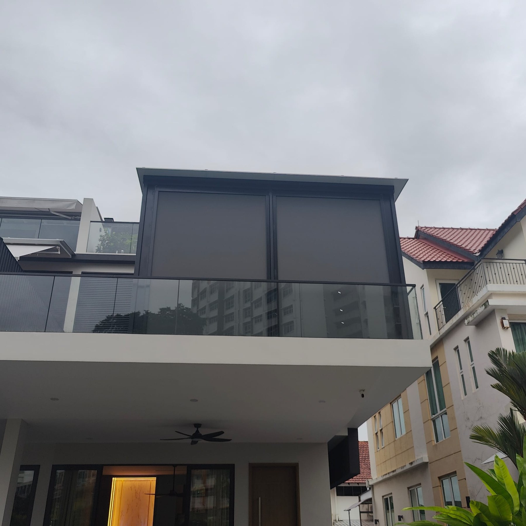 Landed home in Singapore with zip blinds and roof extension by Roofers